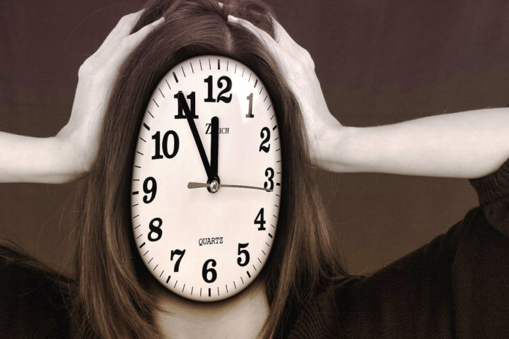 Woman with a clock face for a face.